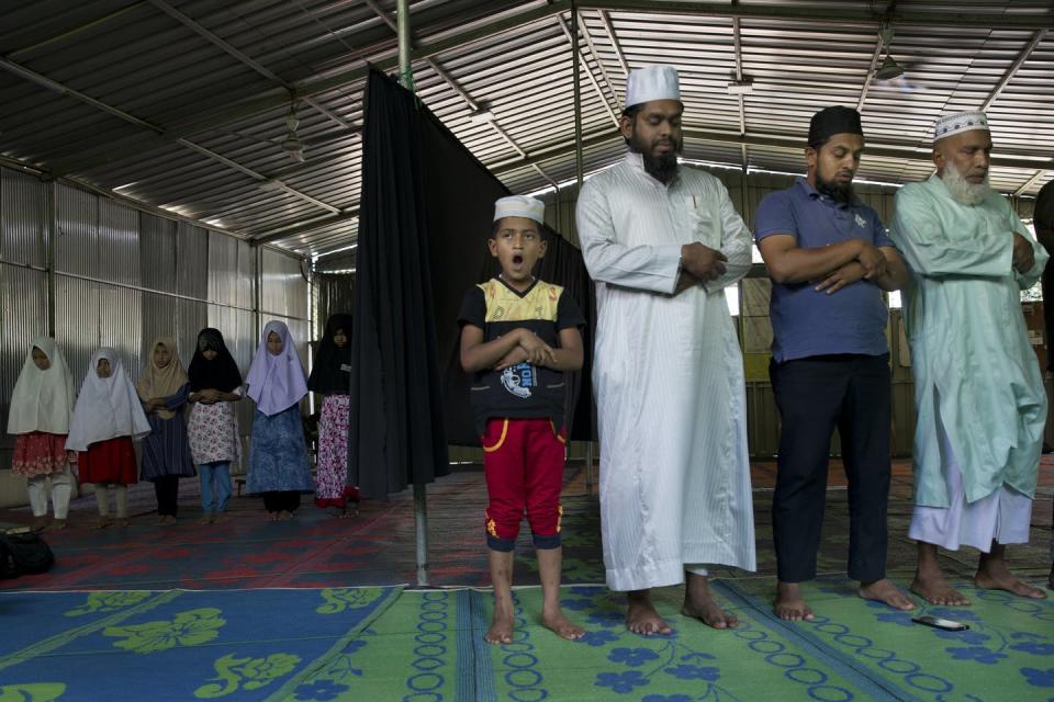 <span class="caption">In this Nov. 14, 2019 photo, Muslims offer prayers inside a temporary mosque set up next to a mosque damaged by a mob during 2018 riots in the outskirts of Kandy, Sri Lanka.</span> <span class="attribution"><a class="link " href="https://newsroom.ap.org/detail/SriLankaMilitantMonks/2af61fca20834060b279dbdf301e0992/photo?Query=sri%20lanka%20muslim&mediaType=photo&sortBy=arrivaldatetime:desc&dateRange=Anytime&totalCount=954&currentItemNo=81" rel="nofollow noopener" target="_blank" data-ylk="slk:AP Photo/Dar Yasin;elm:context_link;itc:0;sec:content-canvas">AP Photo/Dar Yasin</a></span>