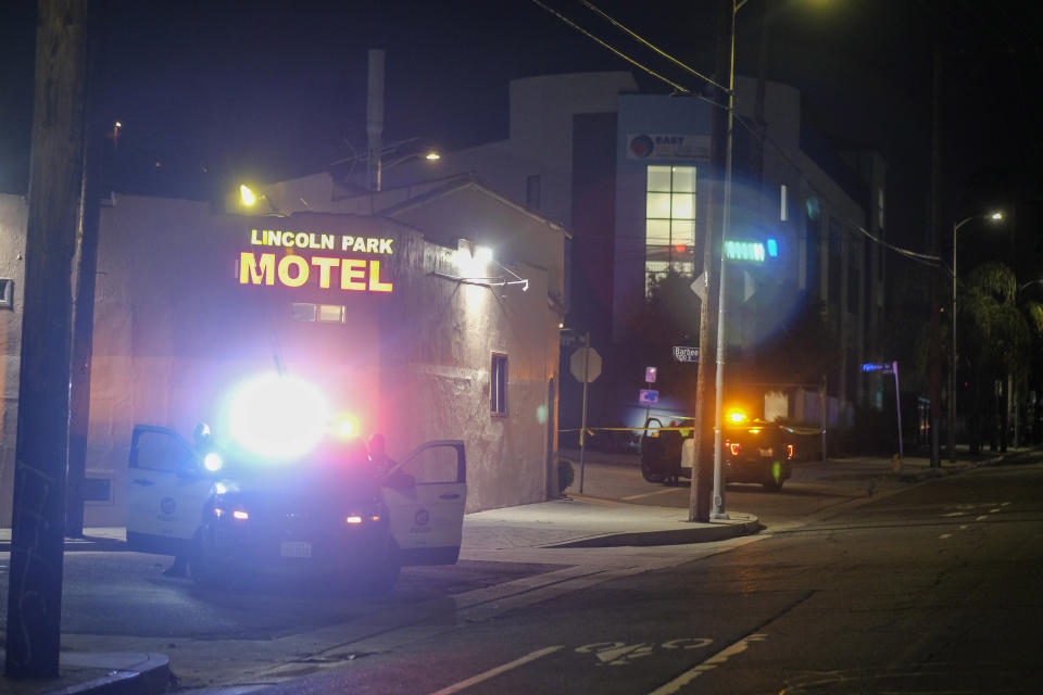Police officers guard near a crime scene where three Los Angeles police officers were shot, Wednesday, March 8, 2023, in Los Angeles. Police said the officers were hospitalized and in stable condition. (AP Photo/Ringo H.W. Chiu)