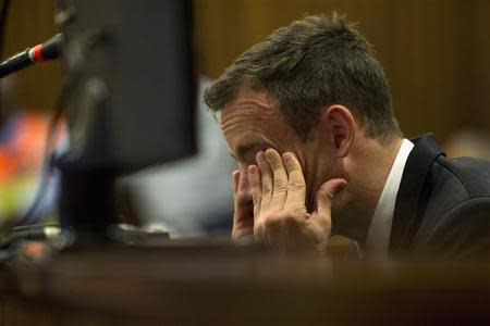 Oscar Pistorius reacts during his trial at the high court in Pretoria April 7, 2014. REUTERS/Deaan Vivier/Pool