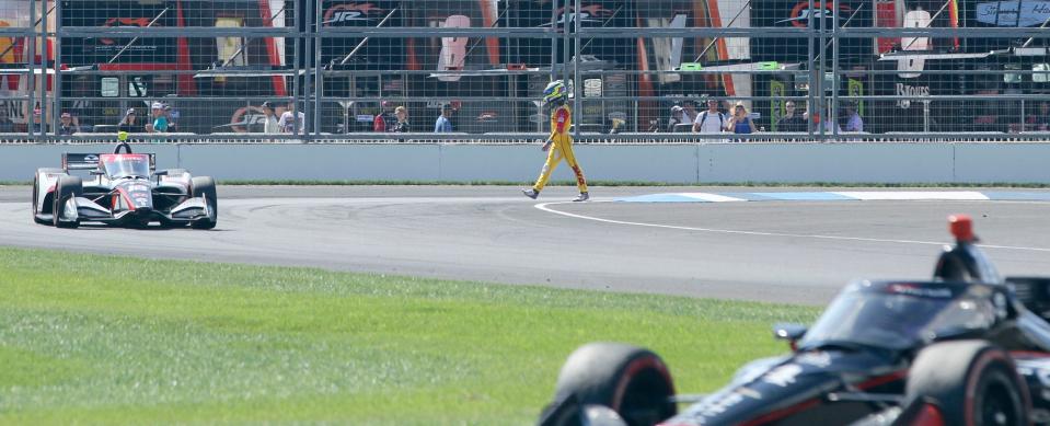 Andretti Autosport driver Romain Grosjean (28) walks off the track Saturday, Aug. 12, 2023, during the Gallagher Grand Prix at Indianapolis Motor Speedway.