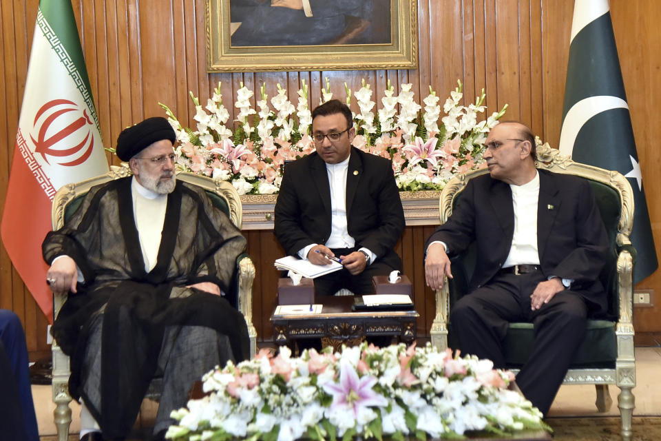 In this photo released by Press Information Department, Iranian President Ebrahim Raisi, left, holds a meeting with his Pakistani counterpart Asif Ali Zardari, right, at the President house in Islamabad, Pakistan, Monday, April 22, 2024. Iranian and Pakistani leaders vowed to strengthen economic and security cooperation in a meeting on Monday, as the two countries seek to smooth over a diplomatic rift. (Press Information Department via AP)