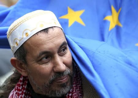 Mimoun El Hachmi Imam of Terni holds a European flag during a demonstration called "Not in my name" of Italian muslims against terrorism, in downtown Rome, Italy, November 21, 2015. REUTERS/Stefano Rellandini