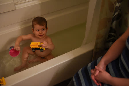 Lauren Hoffmann, 29, a college program manager, bathes her two-year old son Asa on her last day of maternity leave in San Antonio, Texas, U.S., February 12, 2019. REUTERS/Callaghan O'Hare