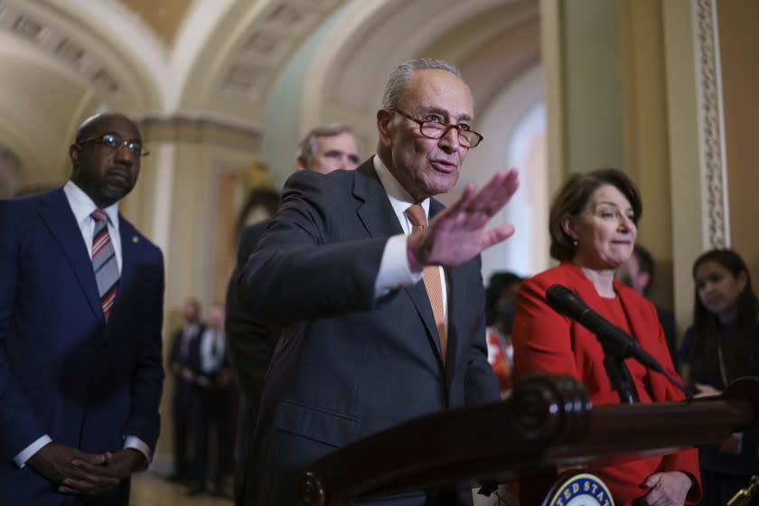 Senate Majority Leader Chuck Schumer, D-N.Y., flanked by Sen. Raphael Warnock, D-Ga., left, and Sen. Amy Klobuchar, D-Minn., speaks with reporters before a key test vote on the For the People Act, a sweeping bill that would overhaul the election system and voting rights, at the Capitol in Washington, Tuesday, June 22, 2021. The bill is a top priority for Democrats seeking to ensure access to the polls and mail in ballots, but it is opposed by Republicans as a federal overreach. (AP Photo/J. Scott Applewhite)