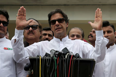 Cricket star-turned-politician Imran Khan, chairman of Pakistan Tehreek-e-Insaf (PTI), speaks to members of media after casting his vote at a polling station during the general election in Islamabad, Pakistan, July 25, 2018. REUTERS/Athit Perawongmetha/Files