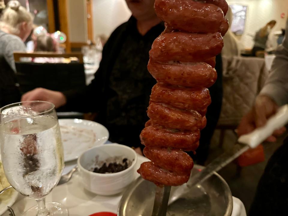 sausage on a skewer at a table in fogo de chao