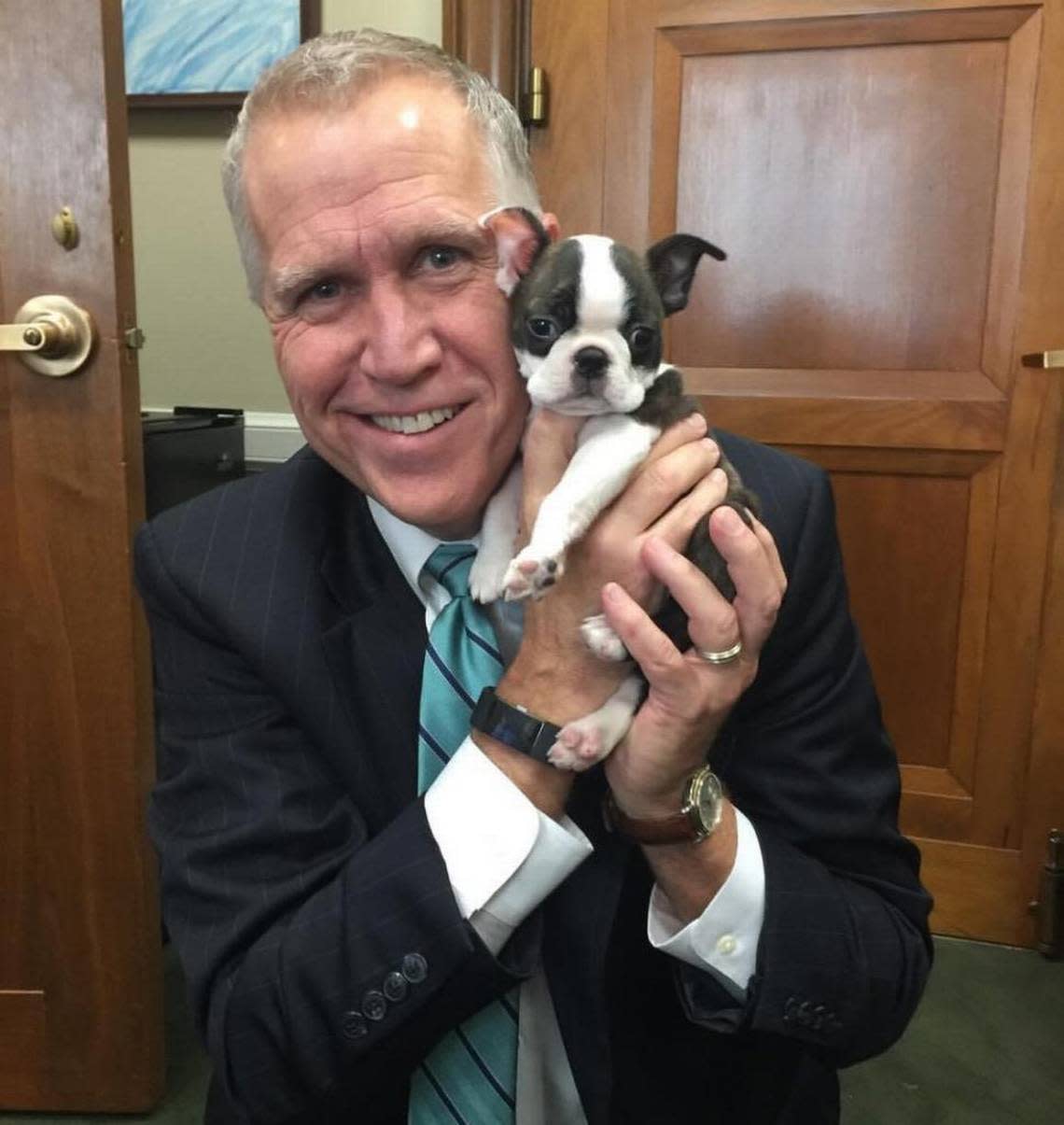 Sen. Thom Tillis, a North Carolina Republican, poses with his office dog, Tilly.