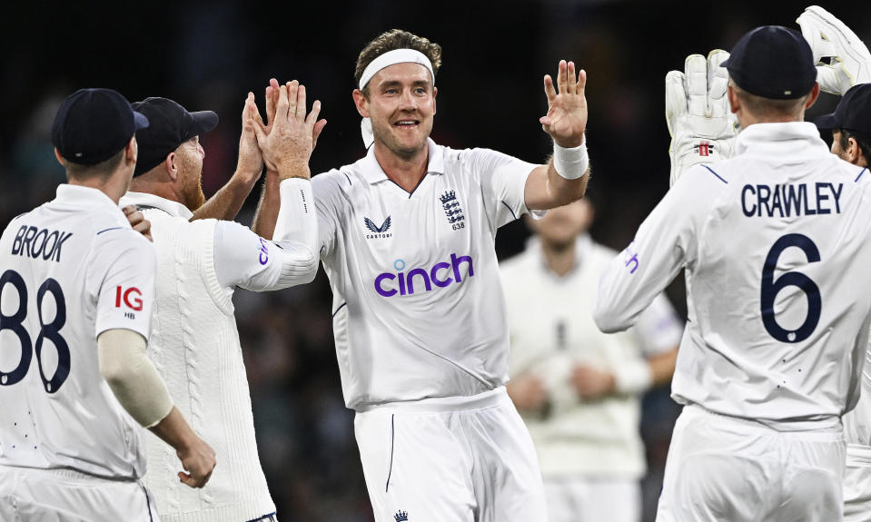 England's Stuart Broad, center, celebrates with teammates after taking the wicket of New Zealand's Kane Williamson on the third day of their cricket test match in Tauranga, New Zealand, Saturday, Feb. 18, 2023. (Andrew Cornaga/Photosport via AP)