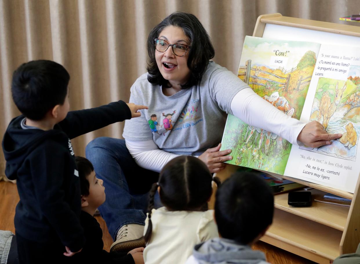 Norma Zapien, La Escuelita program coordinator, reads "Is Your Mama a Llama?" in Spanish and English on Feb. 1 in Green Bay.