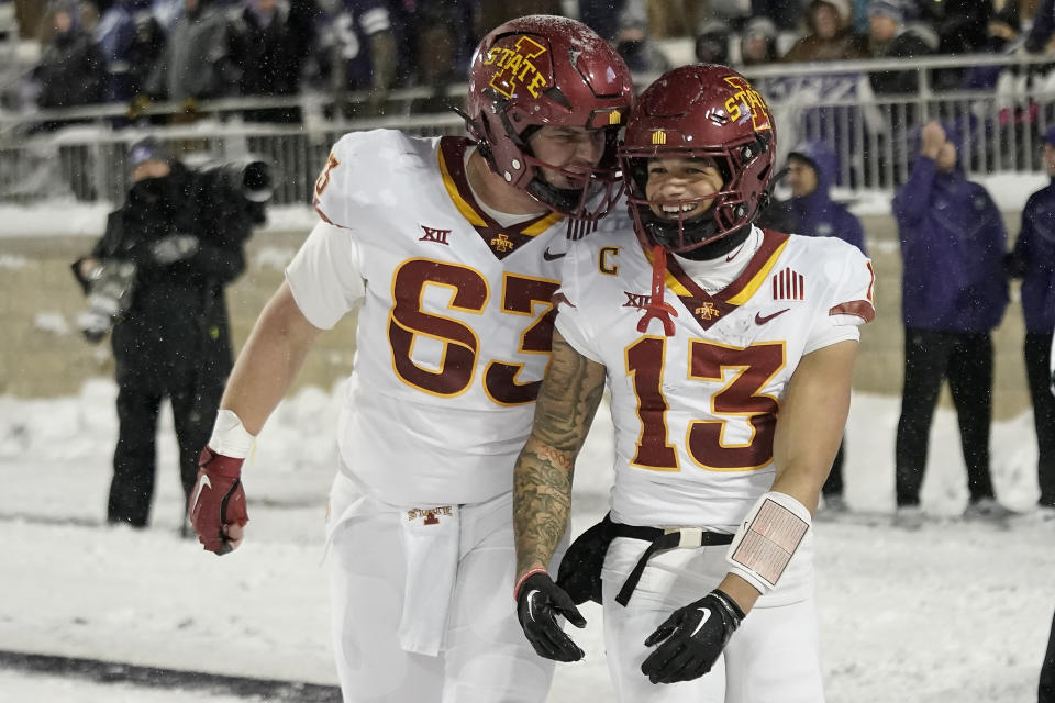 Iowa State wide receiver Jaylin Noel (13) celebrates with offensive lineman Jim Bonifas (63) after scoring a touchdown during the second half of an NCAA college football game against Kansas State Saturday, Nov. 25, 2023, in Manhattan, Kan. Iowa State won 42-35. (AP Photo/Charlie Riedel)