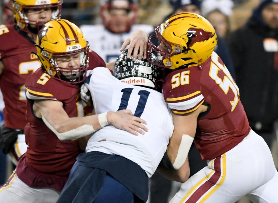 New Bremen's David Homan and Evan Eyink stop Warren John F. Kennedy Eagles Caleb Hadley n the fourth quarter of OHSAA Division VII State Championship football game at Tom Benson Hall of Fame Stadium. Saturday, December 03, 2022.