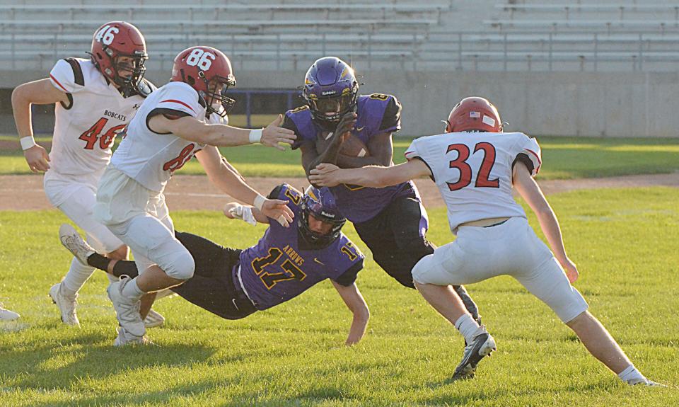 Watertown's Juven Hudson cuts against Brookings defenders Gabriel Stern (46), Egan Jensen (86) and Cash Sather (32) on the way to a 75-yard kickoff return to start  their high school football opener on Friday, Aug. 25, 2023 at Watertown Stadium. Also pictured in Watertown's Markus Pitkin.