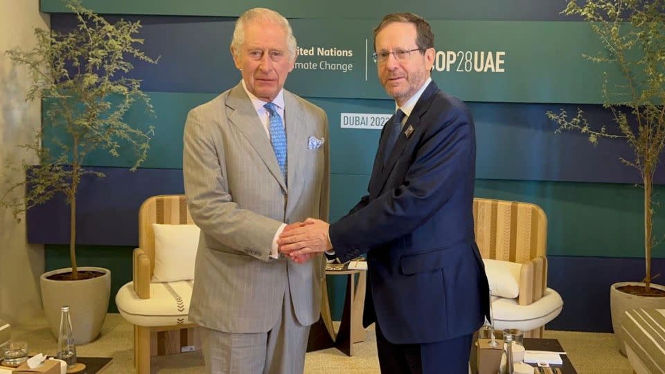 The UK's King Charles III shakes hands with Israeli President Isaac Herzog at the COP28 climate talks in Dubai on December 1, 2023. - Israeli Presidential Press Office/Handout/Reuters