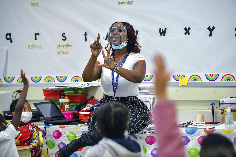 FILE — First grade teacher Keyana Gardner teaches her class at Glenmount Elementary/Middle School, Nov. 1, 2021, in Baltimore, Md. In a number of states including Maryland and Virginia, districts have been dropping and reimposing mask requirements to adapt to the latest virus numbers. (Jerry Jackson/The Baltimore Sun via AP, File)