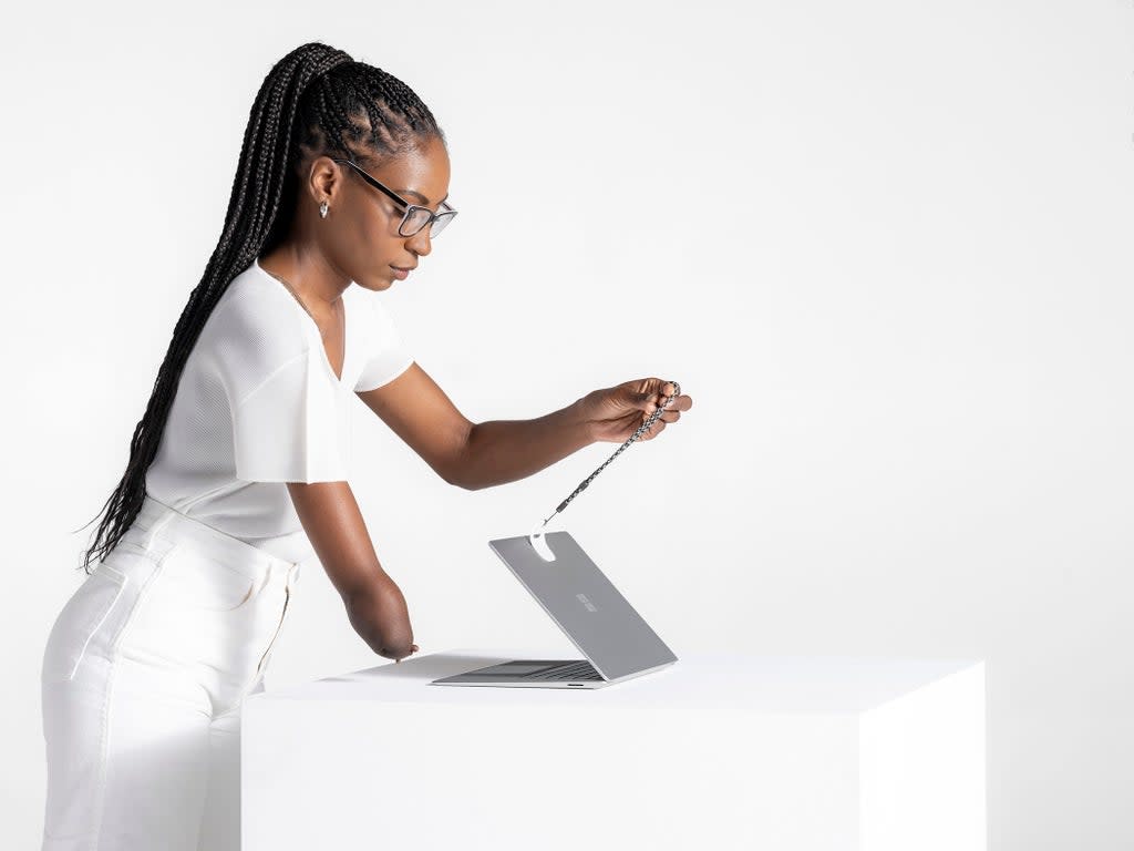 Microsoft’s Surface Adaptive kit being used to help open a laptop (Microsoft/PA)