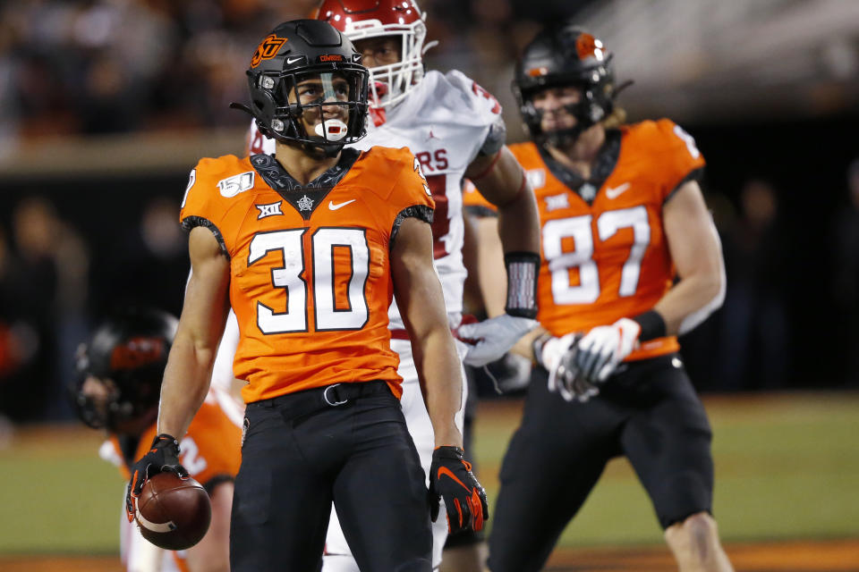 Oklahoma State running back Chuba Hubbard (30) celebrates after a carry against Oklahoma in the first half of an NCAA college football game in Stillwater, Okla., Saturday, Nov. 30, 2019. (AP Photo/Sue Ogrocki)