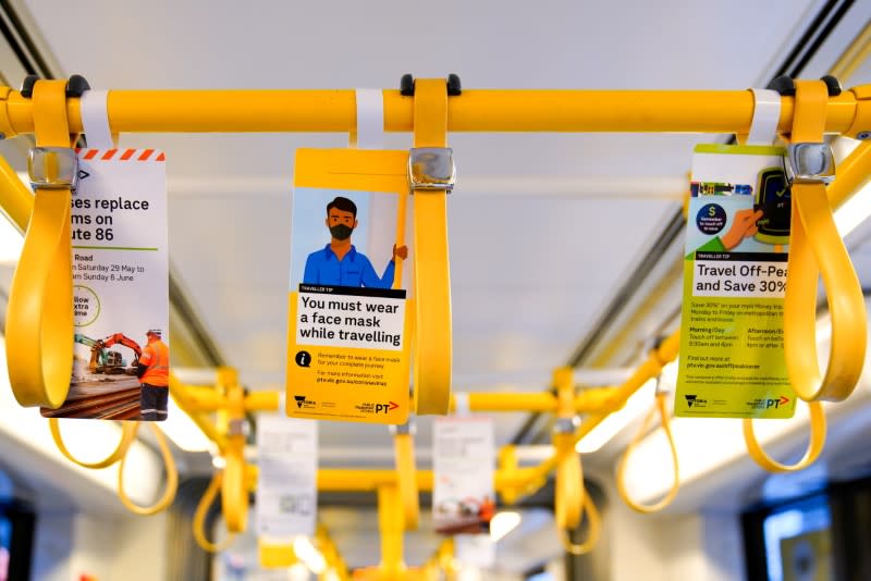 FILE PHOTO: A sign regarding mandatory mask wearing is seen on a tram in Melbourne