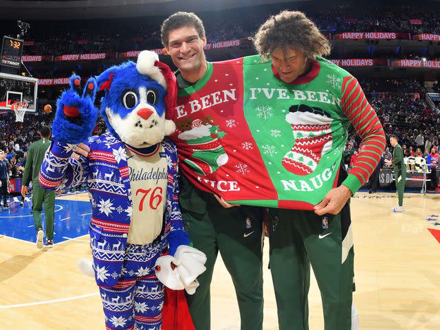 <p>Jesse D. Garrabrant/NBAE/Getty</p> Brook Lopez and Robin Lopez pose for a photo before the game against the Philadelphia 76ers on December 25, 2019 in Philadelphia, Pennsylvania.