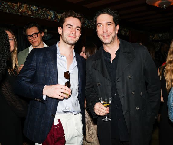 <p>BFA</p> David Schwimmer (right) poses with a guest at Raf's first anniversary party