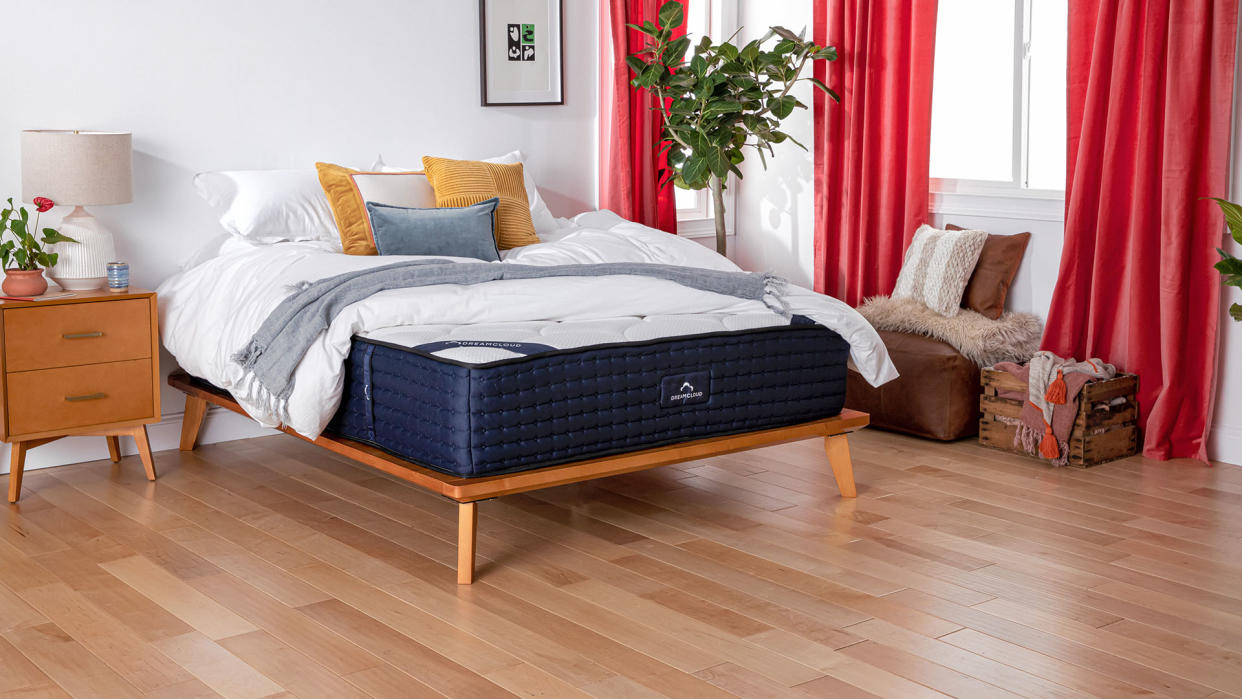  DreamCloud Mattress Review lead image, featuring a DreamCloud Mattress with sheets and pillows on top. 