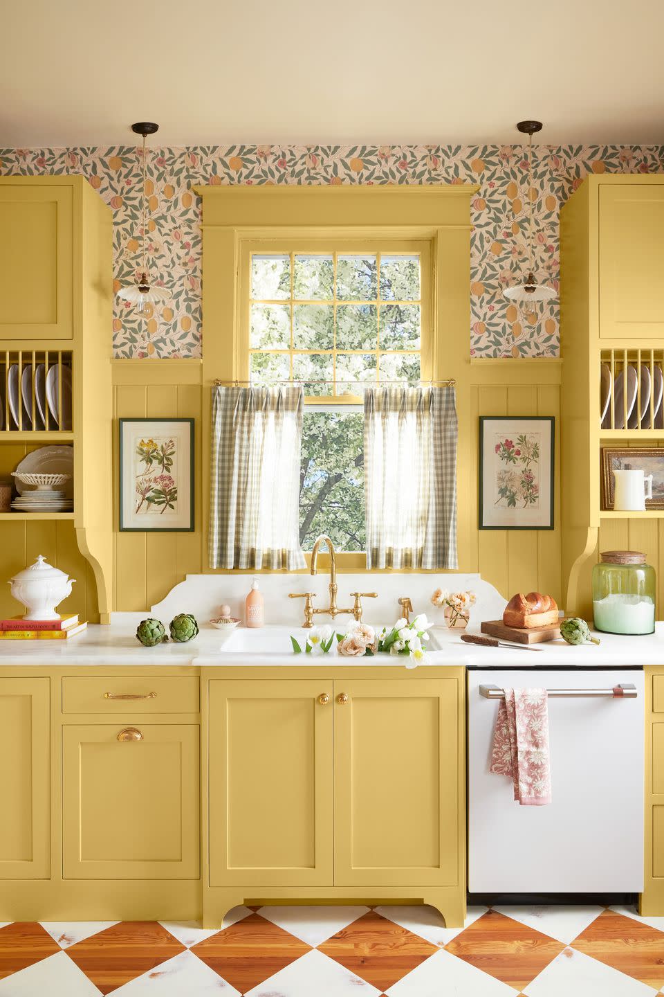 sink surrounded by yellow built in cabinets, cafe curtains