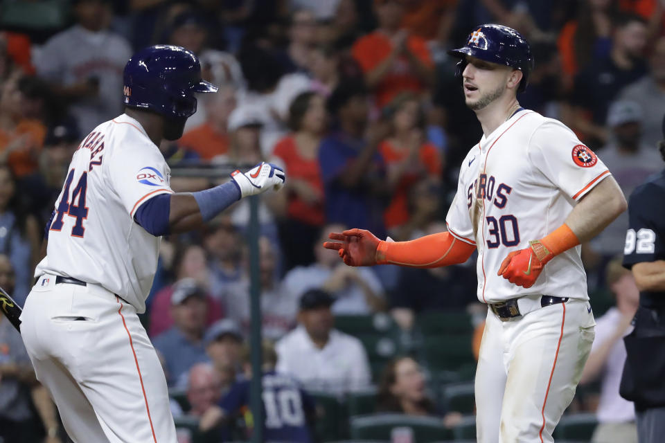 Houston Astros' Yordan Alvarez, left, and Kyle Tucker celebrate Tucker's second solo home run of the night, against the Los Angeles Angels during the seventh inning of a baseball game Tuesday, May 21, 2024, in Houston. (AP Photo/Michael Wyke)