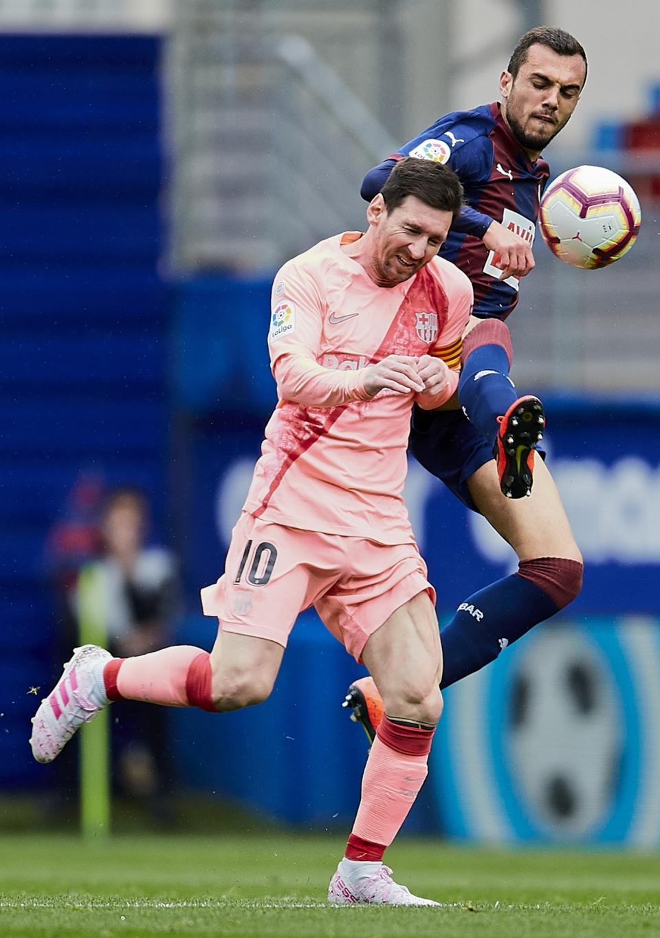 Barcelona's Lionel Messi, left, duels for the ball against Eibar's Joan Jordan during a Spanish La Liga soccer match at the Ipurua stadium, in Eibar, northern Spain, Sunday, May 19, 2019. (AP Photo/Ion Alcoba)