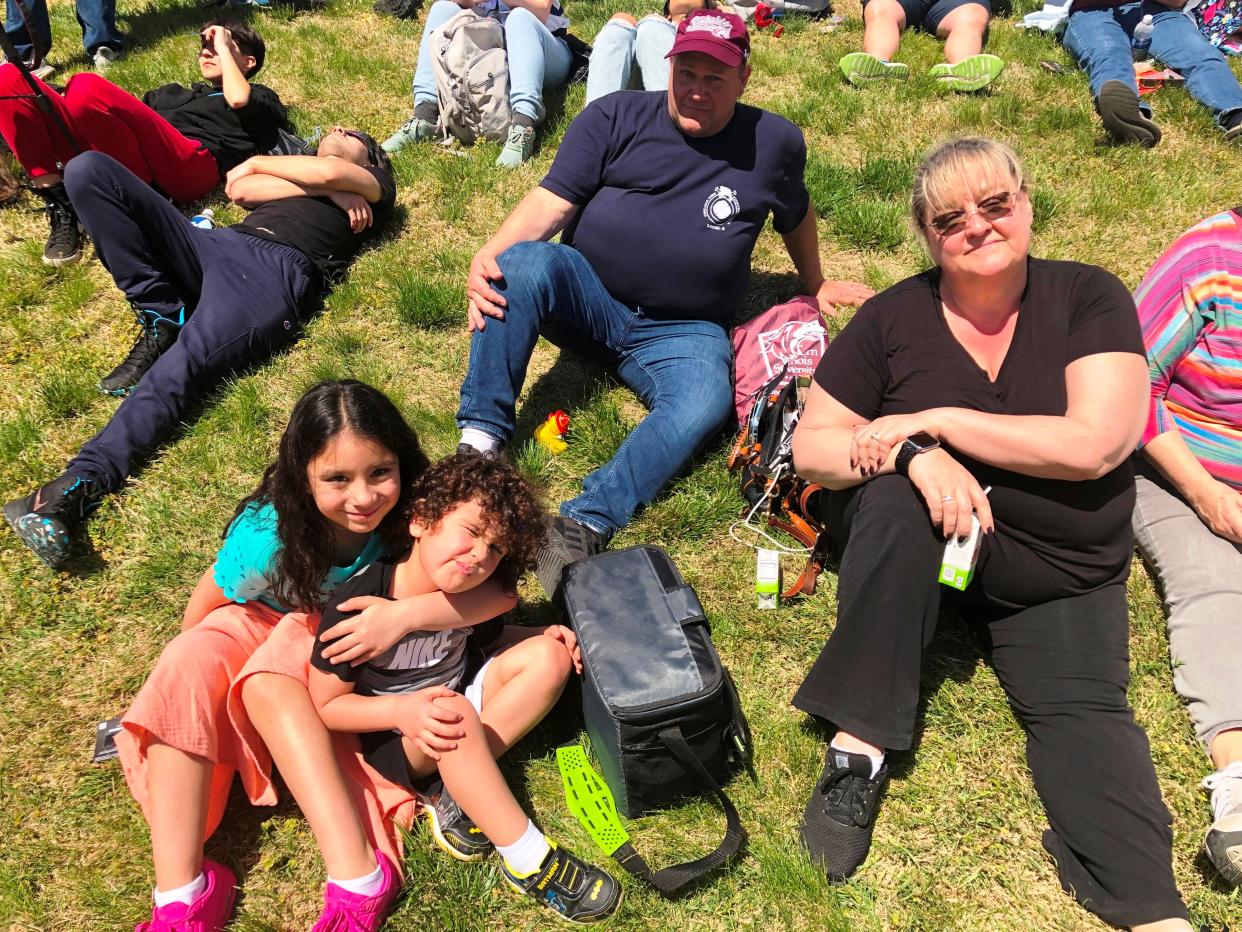 Michelle and Ron Krouse, of Chicago, brought grandchildren Amara, 8, and Javier, 3, to see the total eclipse on Monday, April 8, 2024 at Saluki Stadium in Carbondale.