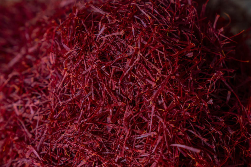Dried Stigmas of the crocus flowers are grouped together after being separated from the petals in Shaar-i-Shalli village, south of Srinagar, Indian controlled Kashmir, on Oct. 30, 2022. As climate change impacts the production of prized saffron in Indian-controlled Kashmir, scientists are shifting to a largely new technique for growing one of the world’s most expensive spices in the Himalayan region: indoor cultivation. Results in laboratory settings have been promising, experts say, and the method has been shared with over a dozen traditional growers. (AP Photo/Dar Yasin)