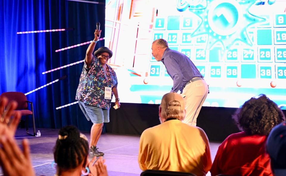 Virginia Mayo Holland of Berlin (left) dances and celebrates with 50th Anniversary Cash Bash Host Derek Gwaltney of Atlas Experiences (right) after winning her $100,000 prize at the Maryland State Fair in Timonium on September 8, 2023.