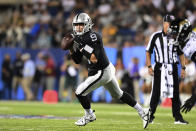 Las Vegas Raiders quarterback Nick Mullens rolls out looking to pass during the first half of the team's NFL football exhibition Hall of Fame Game against the Jacksonville Jaguars, Thursday, Aug. 4, 2022, in Canton, Ohio. (AP Photo/David Dermer)