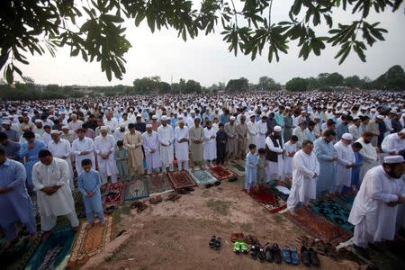 People attend Eid al-Fitr prayers to mark the end of the holy fasting month of Ramadan in a park in Peshawar, Pakistan June 25, 2017. REUTERS/ Fayaz Aziz