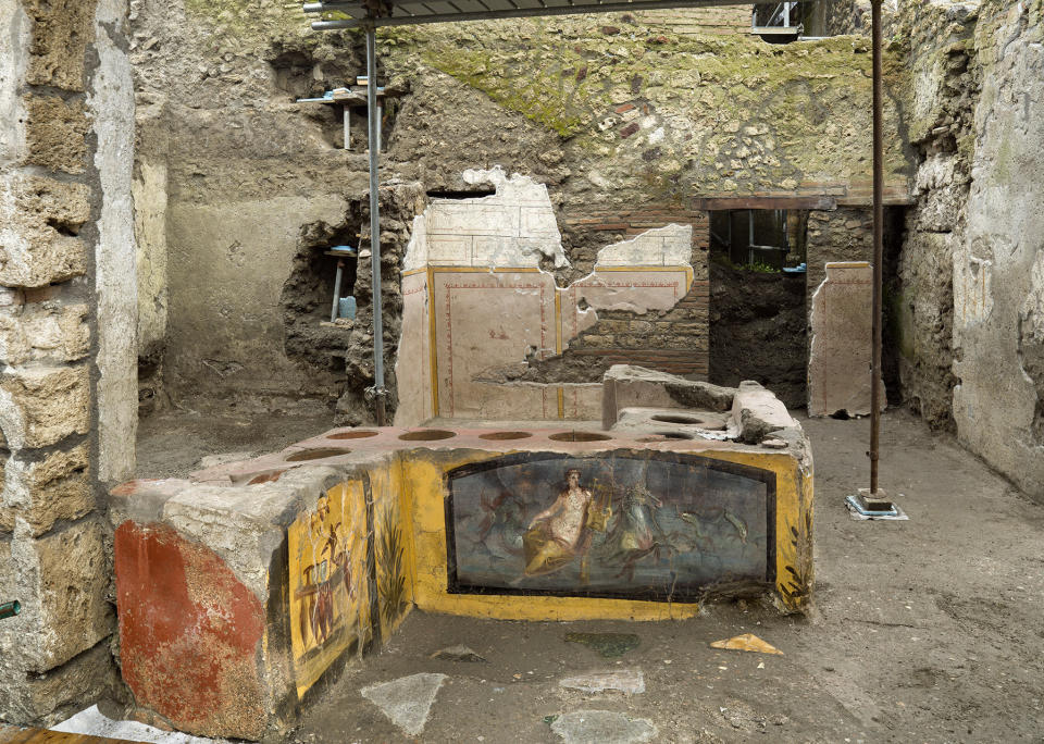 An undated photo made available by the Pompeii Archeological park press office shows the thermopolium in the Pompeii archeological park, near Naples, Italy. A fast-food eatery discovered at Pompeii is now completely excavated, helping to reveal some favorite dishes of citizens of the ancient Roman city who liked to eat out. Pompeii Archaeological Park’s longtime chief, Massimo Osanna said Saturday, Dec. 26, 2020, in a statement that while some 80 such fast-foods have been found at Pompeii, it is the first time such an eatery — known as a thermopolium since it serve hot foods — had been entirely excavated. (Luigi Spina/Parco Archeologico di Pompei via AP)