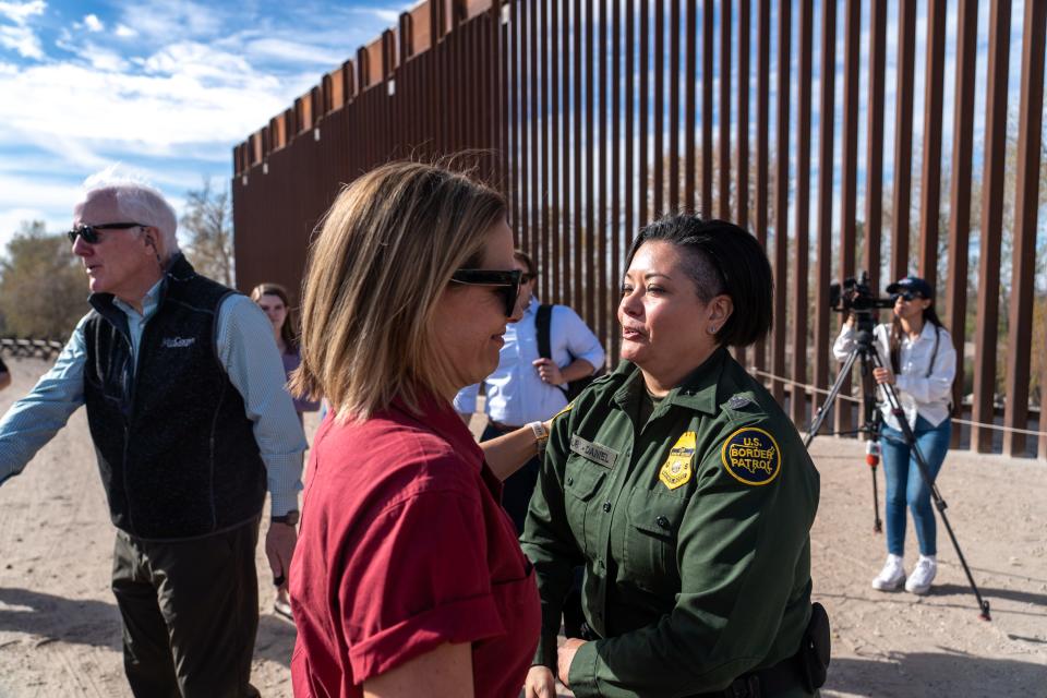 U.S. Sen. Kyrsten Sinema, I-Ariz., left, and Patricia McGurk-Daniel, U.S. Border Patrol Yuma sector acting chief patrol agent, right, shake hands during a visit to the U.S.-Mexico border in Somerton, Ariz., near the Cocopah Indian Reservation boundary on Jan. 10, 2023.
