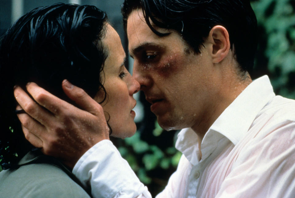 A man and woman are about to kiss, man's face shows injury, in an emotionally intense scene