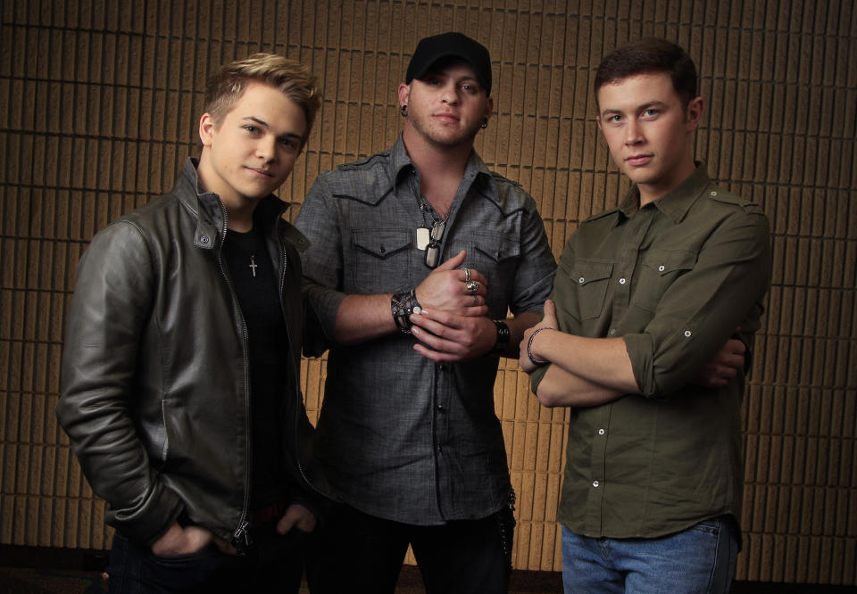 This March 8, 2012 photo shows Hunter Hayes, left, Brantley Gilbert, center, and Scotty McCreery, right, in Nashville, Tenn. The fan-voted top new artist category at the Academy of Country Music Awards features all three. (AP Photo/Mark Humphrey)