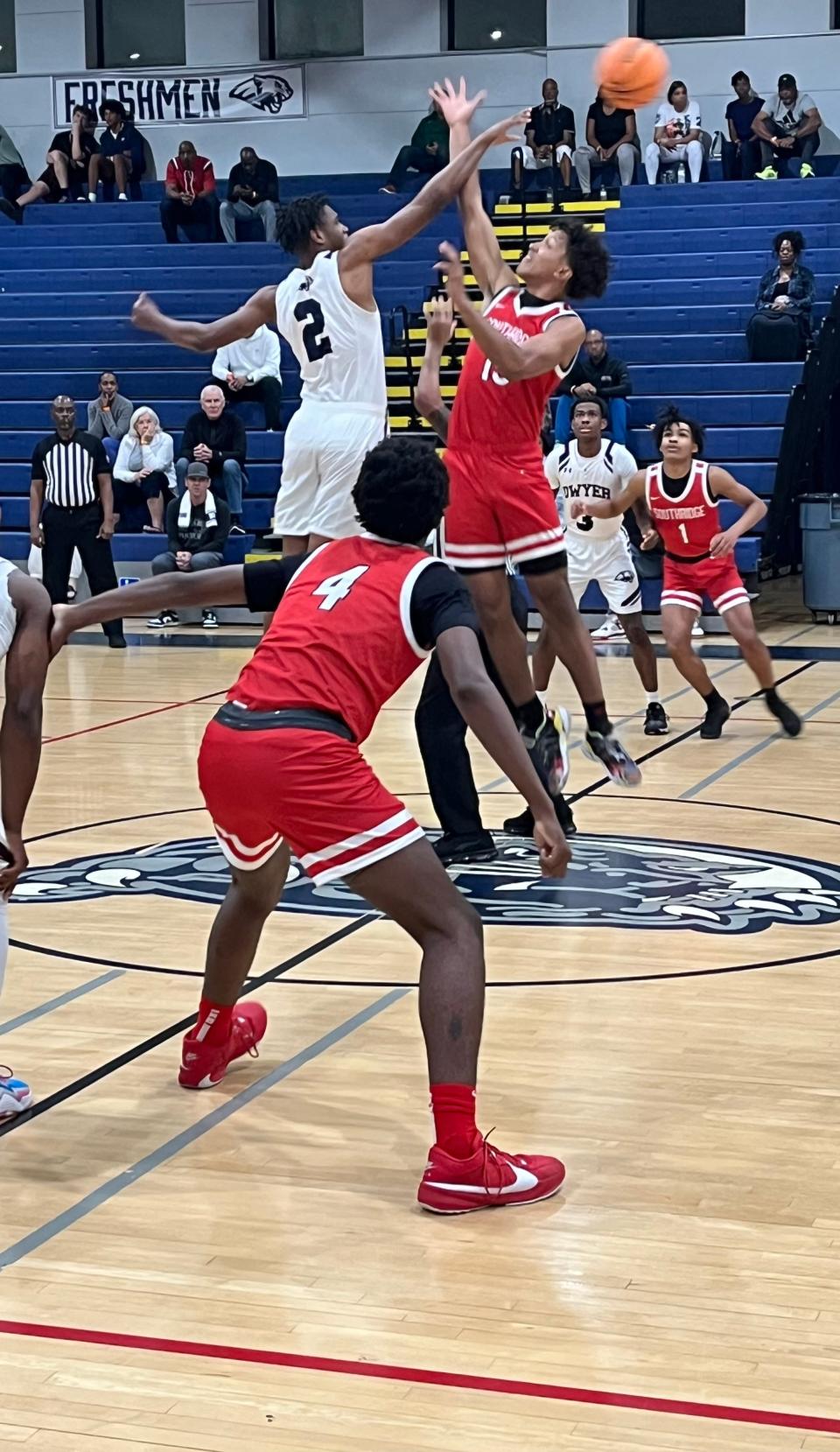 Dwyer's Amari Nealy (2) wins the opening tip against Southridge's Jan Lopez on Thursday night in a Region 4-6A quarterfinal game in Palm Beach Gardens.