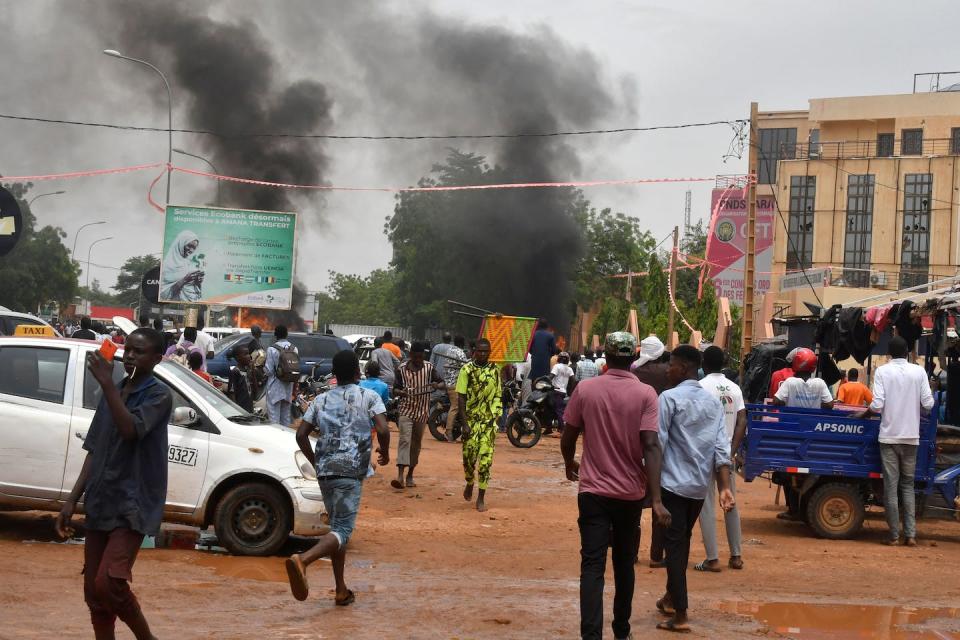 Pro-coup demonstrators attack the headquarters of the party of overthrown President Mohamed Bazoum. <a href="https://www.gettyimages.com/detail/news-photo/general-view-of-billowing-smoke-as-supporters-of-the-news-photo/1557046635?adppopup=true" rel="nofollow noopener" target="_blank" data-ylk="slk:AFP via Getty Images;elm:context_link;itc:0;sec:content-canvas" class="link ">AFP via Getty Images</a>