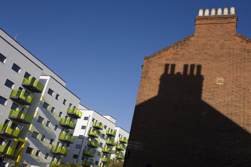 Old Edwardian brick housing alongside new apartments in a block developed by Skanska in Coldharbour Lane in Camberwell, Lambeth, South London. The new building's balconies have fluouerscent green that looks garish in the afternoon sunlight, similar to the high-visibility tabards of nearby constructions workers. Whilst known mainly for large high-profile schemes, Skanska also undertake many smaller projects including public realm improvements, involved in some of the UK's most prestigious projects in both the Private and Public Sectors. (Photo by In Pictures Ltd./Corbis via Getty Images)