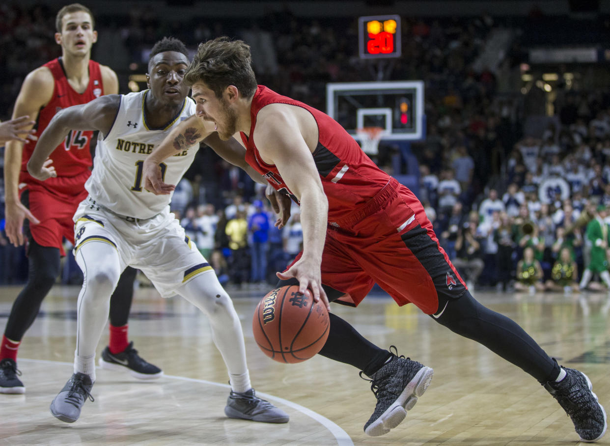 Ball State’s Tayler Persons (2) drives by Notre Dame’s T.J. Gibbs (10) during the first half of an NCAA college basketball game Tuesday, Dec. 5, 2017, in South Bend, Ind. (AP Photo/Robert Franklin)