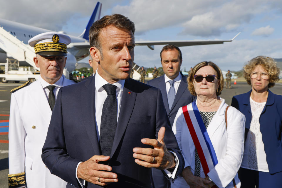 French President Emmanuel Macron gestures as he speaks with the press upon arrival at Noumea ñ La Tontouta International airport, in Noumea, New Caledonia, Thursday, May 23, 2024. Macron has landed in riot-hit New Caledonia, having crossed the globe by plane from Paris in a high-profile show of support for the French Pacific archipelago wracked by deadly unrest and where indigenous people have long sought independence from France. (Ludovic Marin/Pool Photo via AP)