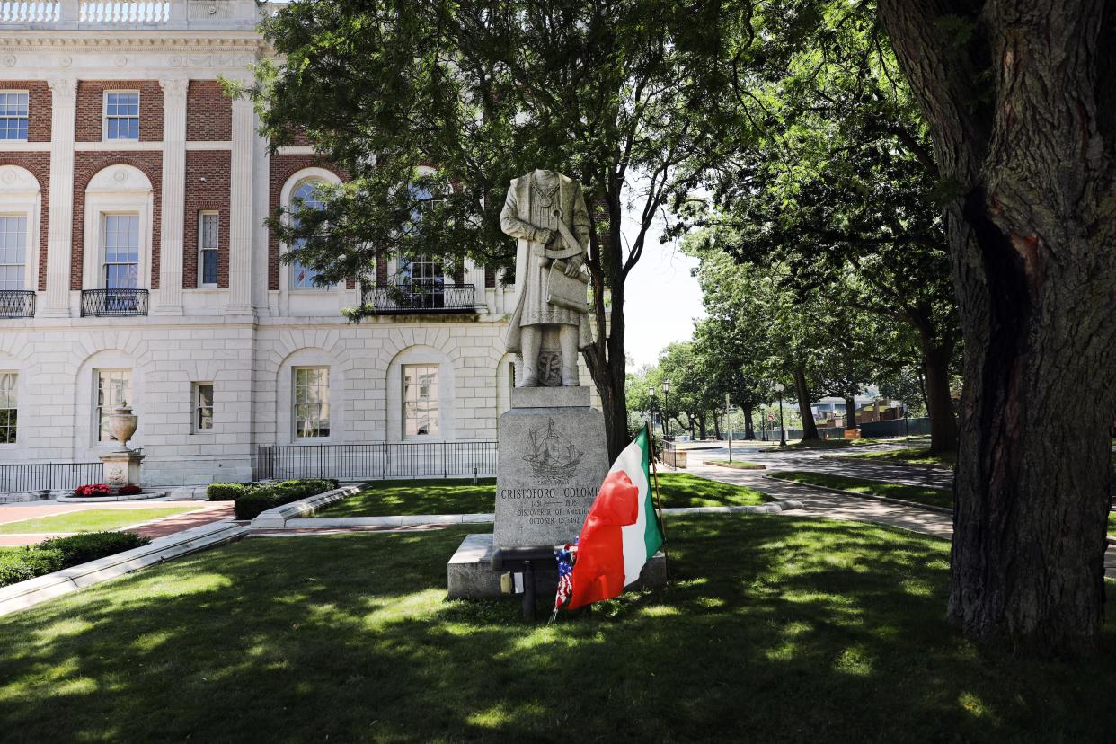 The headless statue of Christopher Columbus stands outside of Waterbury’s City Hall on July 5, 2020, in Waterbury, Conn. The decapitated statue, which was given to the city in the 1980s by Italian American organization UNICO, was discovered Saturday morning and police are investigating. Demonstrators had called for the statue's removal last week in a protest due to the ongoing debate about the explorer's violence against indigenous people.