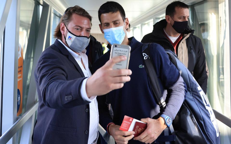 A man takes a selfie with Serbian tennis player Novak Djokovic as he arrives at Nikola Tesla Airport - CHRISTOPHER PIKE /REUTERS