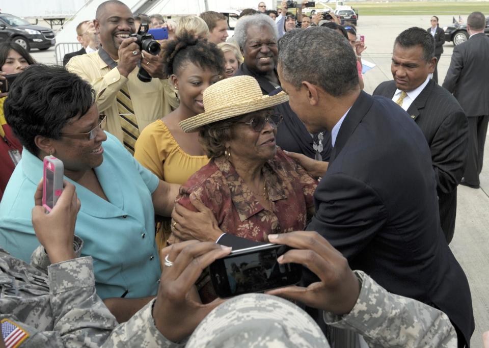 President Barack Obama greets people after arriving at San Antonio International Airport in San Antonio, Texas, Tuesday, July 17, 2012. Obama is spending the day fundraising in Texas. (AP Photo/Susan Walsh)