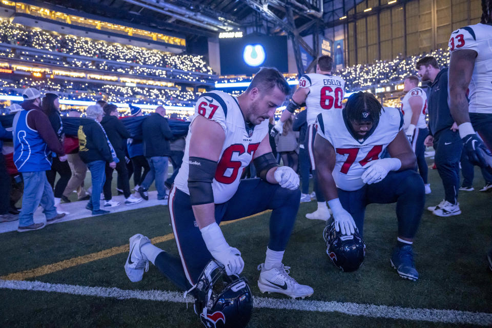 Jan 6, 2024; Indianapolis, Indiana, USA; Houston Texans offensive tackle Charlie Heck (67) and offensive tackle Josh Jones (74) kneel for a minute by the bench before a game against the Indianapolis Colts at Lucas Oil Stadium. Mandatory Credit: Marc Lebryk-USA TODAY Sports