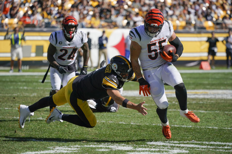 Pittsburgh Steelers quarterback Ben Roethlisberger, front left, tries to tackle Cincinnati Bengals linebacker Logan Wilson (55) after Wilson intercepted his pass during the second half an NFL football game, Sunday, Sept. 26, 2021, in Pittsburgh. (AP Photo/Gene J. Puskar)