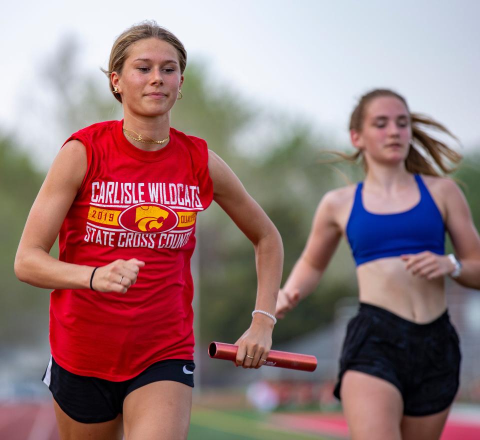 Carlisle senior Ainsley Erzen practices baton handoffs during track practice at the high school on May 11 in Carlisle. Erzen is one of the best athletes in the state, solidifying herself as one of the top track runners and top soccer players. She'll play both at Arkansas.