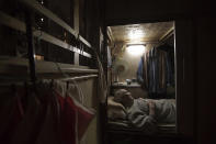 <p>Tse Chu, a retired waiter, sleeps in his “coffin home” in Hong Kong, March 28, 2017. In wealthy Hong Kong, there’s a dark side to a housing boom, with hundreds of thousands of people forced to live in partitioned shoebox apartments, called “coffin homes,” and other forms of inadequate housing. As a new leader for the territory prepares to take office, housing unaffordability remains one of the Asian financial center’s biggest social problems. (Photo: Kin Cheung/AP) </p>