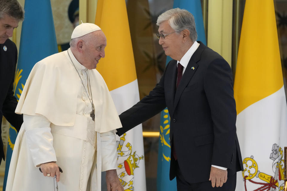 Pope Francis, left, meets the Kazakhstan's President Kassym-Jomart Tokayev as he arrives at Our-Sultan's International airport in Nur-Sultan, Kazakhstan, Tuesday, Sept. 13, 2022. Pope Francis begins a 3-days visit to the majority-Muslim former Soviet republic to minister to its tiny Catholic community and participate in a Kazakh-sponsored conference of world religious leaders. (AP Photo/Andrew Medichini)