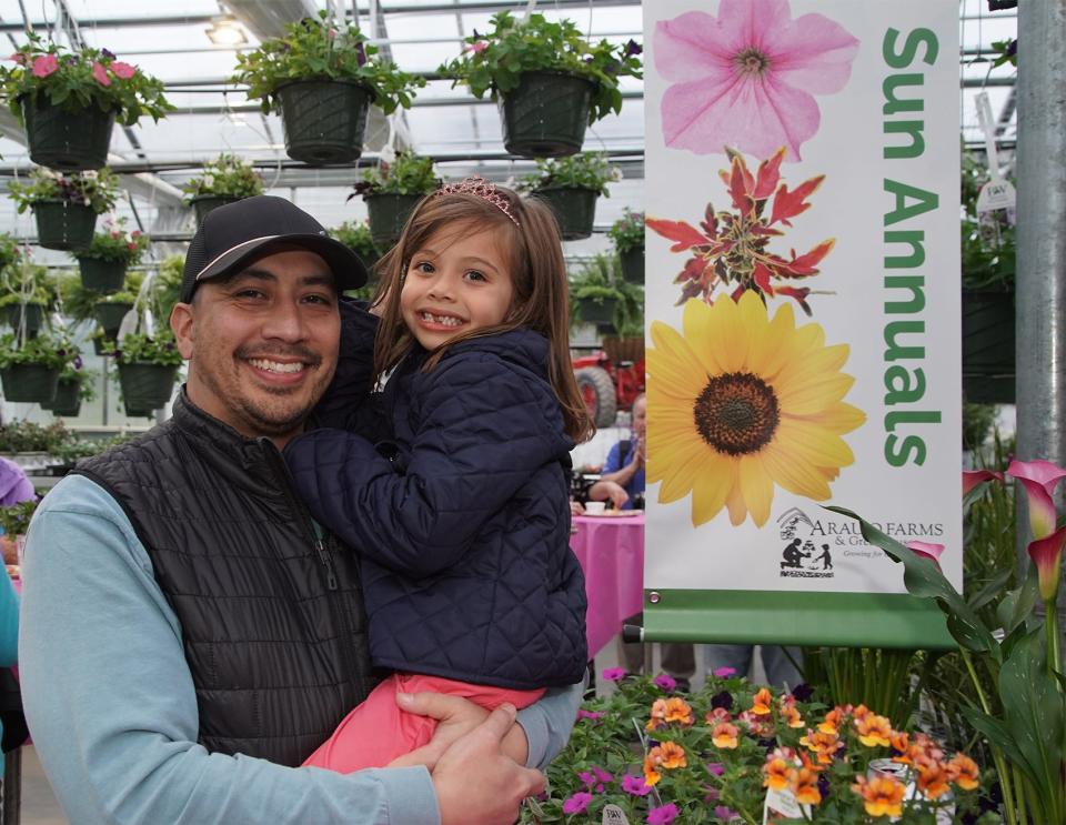 Chris Bacon with his daughter Freia, 6, enjoy  the grand reopening celebration at Araujo Farms in Dighton on Friday April 28, 2023.